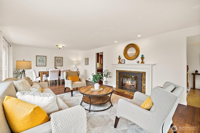 living area featuring wood finished floors, recessed lighting, and a fireplace