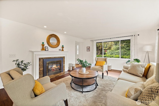living room featuring light wood-style floors, recessed lighting, and a fireplace