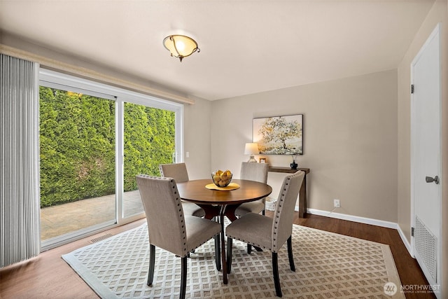dining area with wood finished floors and baseboards