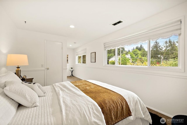 carpeted bedroom featuring baseboards and recessed lighting