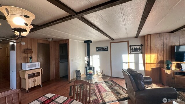 169 Twin Lakes Dr, Winthrop, WA 98862 - living room featuring a wood stove, wooden walls, and wood finished floors