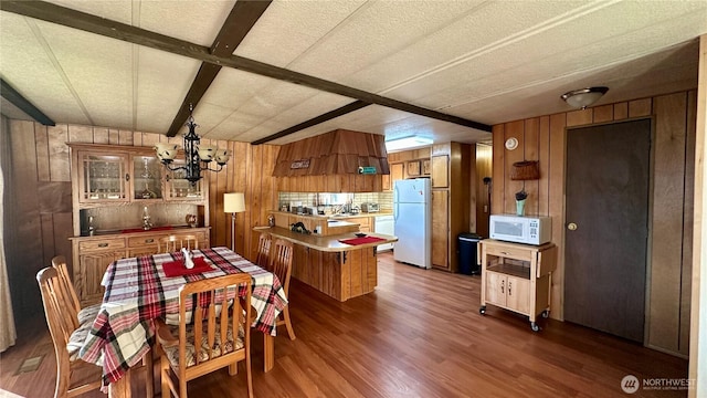 169 Twin Lakes Dr, Winthrop, WA 98862 - dining area with wooden walls, wood finished floors, a chandelier, and beamed ceiling