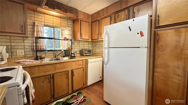 169 Twin Lakes Dr, Winthrop, WA 98862 - kitchen with white appliances, light countertops, decorative backsplash, a sink, and brown cabinets