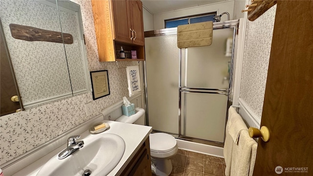 169 Twin Lakes Dr, Winthrop, WA 98862 - bathroom with toilet, vanity, an enclosed shower, tile patterned flooring, and wallpapered walls
