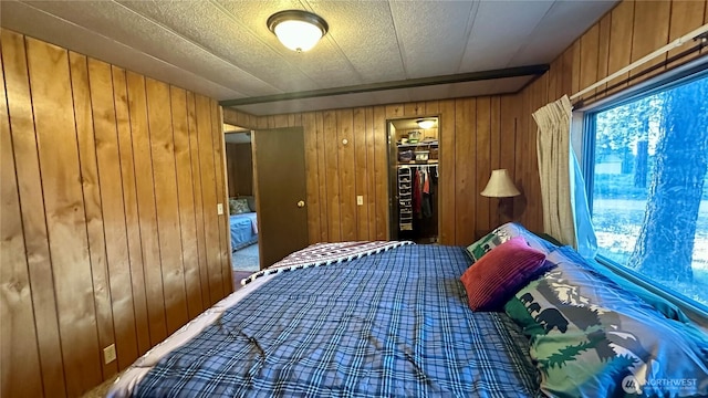 169 Twin Lakes Dr, Winthrop, WA 98862 - bedroom featuring wood walls, a closet, carpet floors, and a walk in closet