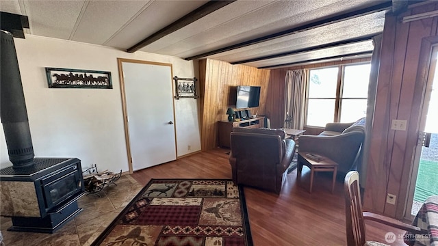 169 Twin Lakes Dr, Winthrop, WA 98862 - living area with a wood stove, beam ceiling, and wood finished floors