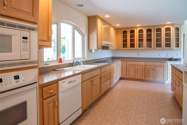 28705 48th Ave NW, Stanwood, WA 98292 - kitchen with white appliances, under cabinet range hood, recessed lighting, glass insert cabinets, and light brown cabinets