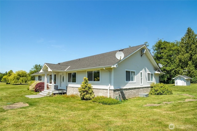 28705 48th Ave NW, Stanwood, WA 98292 - view of front of home featuring a storage unit, a front lawn, and a shingled roof