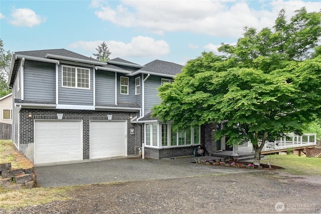 17634 118th Ave SE, Renton, WA 98058 - view of front of house featuring an attached garage, asphalt driveway, brick siding, a wooden deck, and roof with shingles