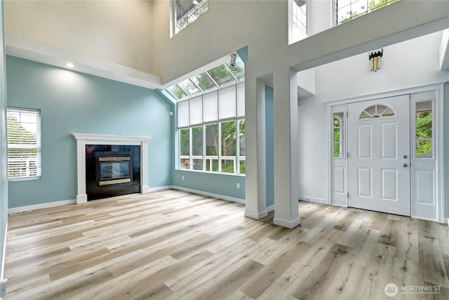 17634 118th Ave SE, Renton, WA 98058 - foyer featuring a high ceiling, healthy amount of natural light, wood finished floors, and baseboards