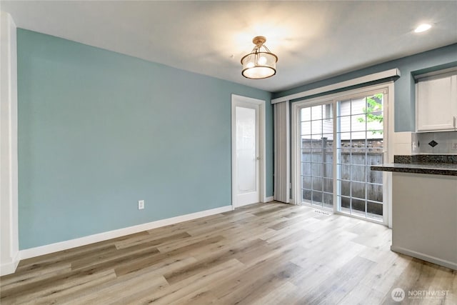 17634 118th Ave SE, Renton, WA 98058 - unfurnished dining area featuring baseboards, light wood-type flooring, and recessed lighting