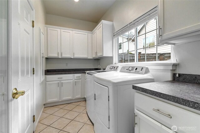 17634 118th Ave SE, Renton, WA 98058 - laundry room featuring separate washer and dryer, cabinet space, and light tile patterned floors
