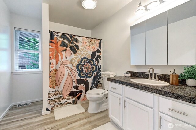 17634 118th Ave SE, Renton, WA 98058 - full bathroom with wood finished floors, toilet, vanity, baseboards, and a shower with shower curtain