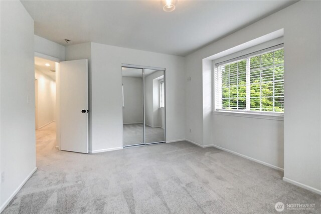 17634 118th Ave SE, Renton, WA 98058 - unfurnished bedroom with carpet floors, baseboards, and a closet