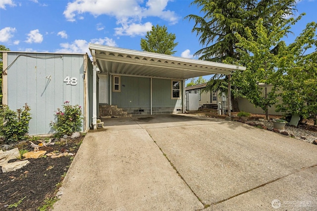 201 W Oakview Ave Unit 48, Centralia, WA 98531 - view of front of house featuring driveway, a shed, an outbuilding, crawl space, and an attached carport