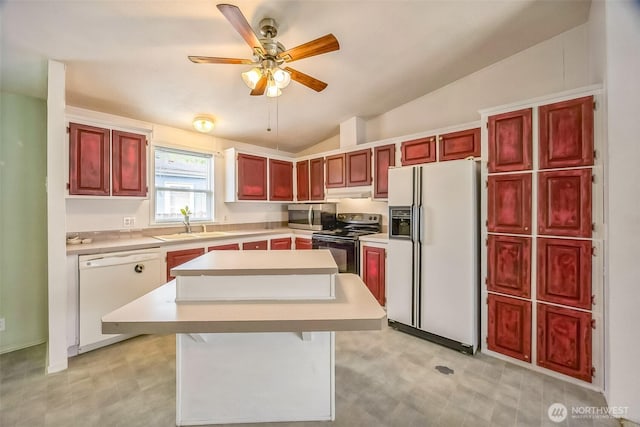 201 W Oakview Ave Unit 48, Centralia, WA 98531 - kitchen with white appliances, dark brown cabinets, vaulted ceiling, a center island, and light countertops