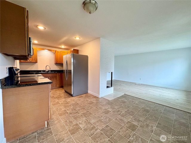 8312 121st St SW, Lakewood, WA 98498 - kitchen with appliances with stainless steel finishes, dark countertops, recessed lighting, a sink, and open floor plan