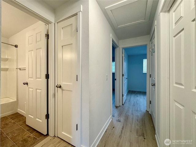 8312 121st St SW, Lakewood, WA 98498 - hall featuring baseboards, light wood-style floors, and attic access