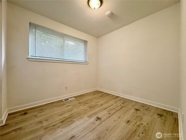 8312 121st St SW, Lakewood, WA 98498 - empty room with light wood-style flooring, baseboards, and a smoke detector