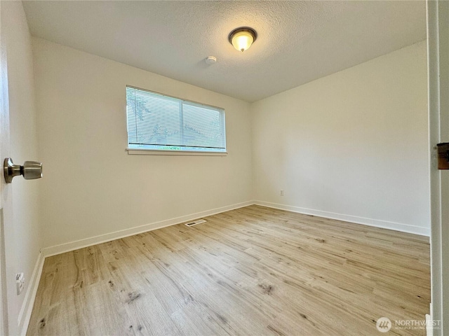 8312 121st St SW, Lakewood, WA 98498 - unfurnished room featuring wood finished floors, baseboards, and a textured ceiling