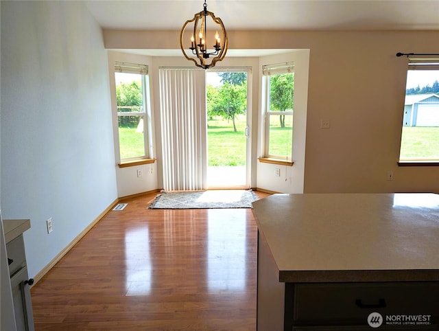 9441 180th Way SW, Rochester, WA 98579 - unfurnished dining area with wood finished floors, baseboards, and a chandelier