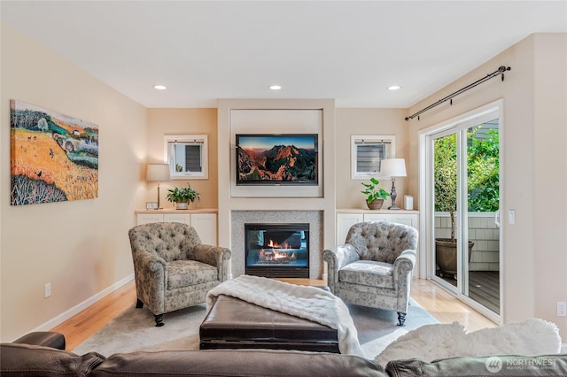 11120 NE 106th Pl, Kirkland, WA 98033 - living room featuring light wood finished floors, baseboards, a glass covered fireplace, and recessed lighting