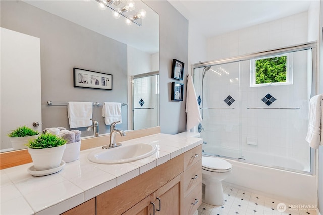 11120 NE 106th Pl, Kirkland, WA 98033 - bathroom featuring vanity, toilet, and shower / bath combination with glass door