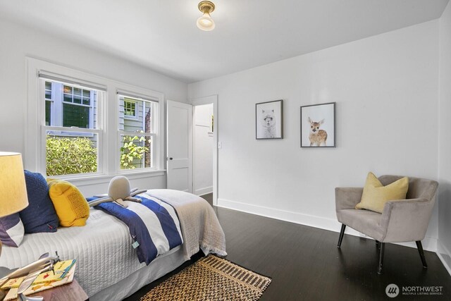 bedroom featuring wood finished floors and baseboards