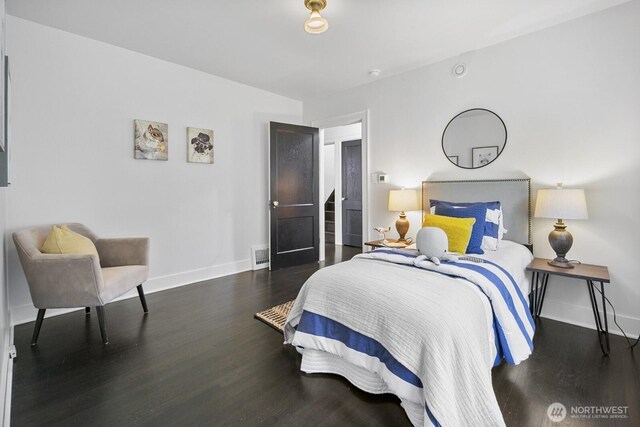 bedroom with wood finished floors and baseboards