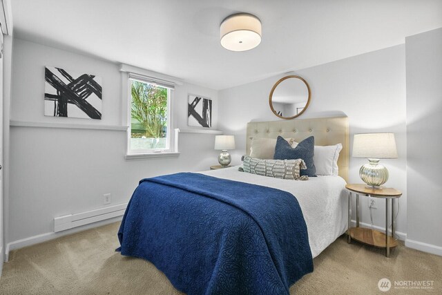 carpeted bedroom featuring baseboard heating and baseboards