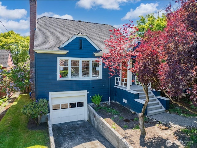 view of front of house featuring concrete driveway, a garage, a chimney, and roof with shingles