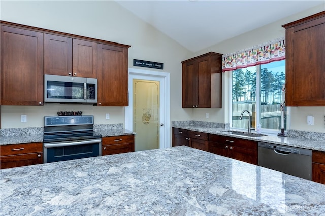 1109 Walker St, Port Angeles, WA 98363 - kitchen featuring stainless steel appliances, a sink, vaulted ceiling, and light stone counters