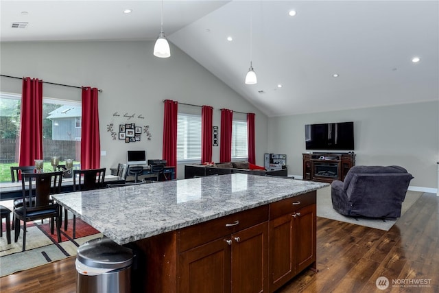1109 Walker St, Port Angeles, WA 98363 - kitchen featuring dark wood finished floors, healthy amount of natural light, pendant lighting, high vaulted ceiling, and light stone counters