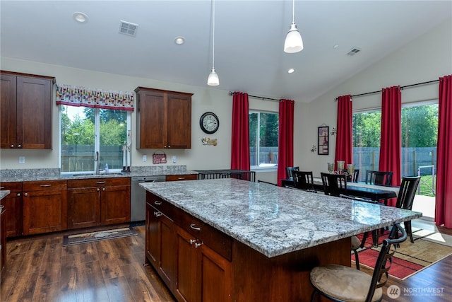 1109 Walker St, Port Angeles, WA 98363 - kitchen with stainless steel dishwasher, vaulted ceiling, a sink, dark wood-type flooring, and a center island