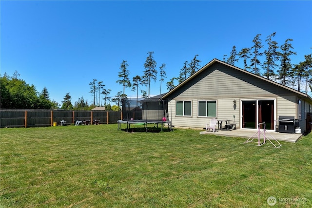 1109 Walker St, Port Angeles, WA 98363 - back of property featuring a trampoline and a patio area