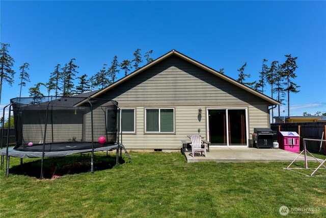 1109 Walker St, Port Angeles, WA 98363 - back of property featuring a trampoline and a patio area