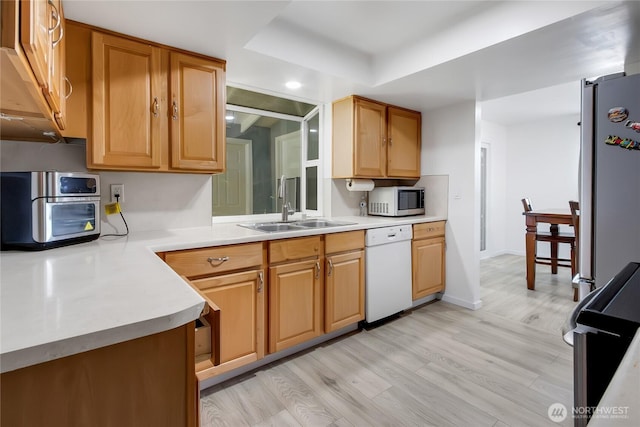 7412 E E St, Tacoma, WA 98404 - kitchen featuring appliances with stainless steel finishes, light countertops, light wood-type flooring, and recessed lighting