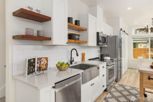 kitchen featuring open shelves, stainless steel appliances, white cabinets, backsplash, and recessed lighting