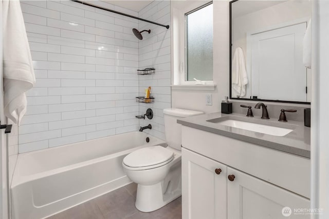 full bath featuring  shower combination, vanity, toilet, and tile patterned flooring