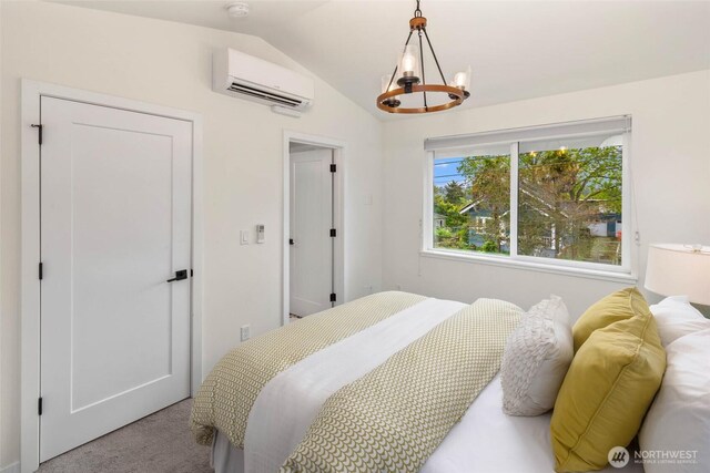 bedroom featuring an AC wall unit, vaulted ceiling, carpet floors, and a chandelier