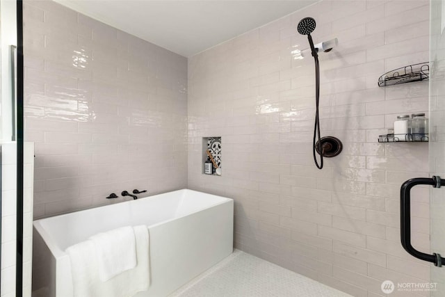 full bath with a tile shower, a soaking tub, and tile walls