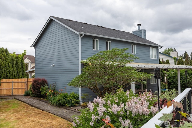 16016 NE 41st St, Vancouver, WA 98628 - back of house with a chimney, fence, and roof with shingles