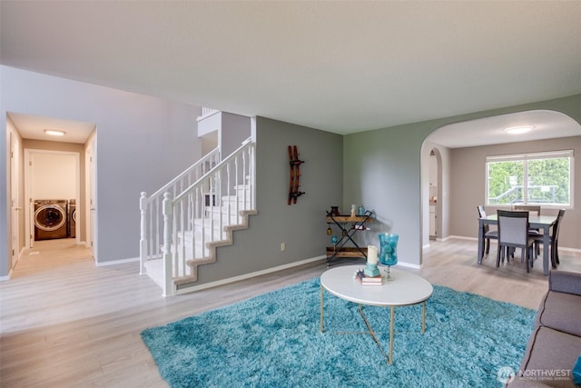 16016 NE 41st St, Vancouver, WA 98628 - living area with arched walkways, wood finished floors, stairs, independent washer and dryer, and baseboards