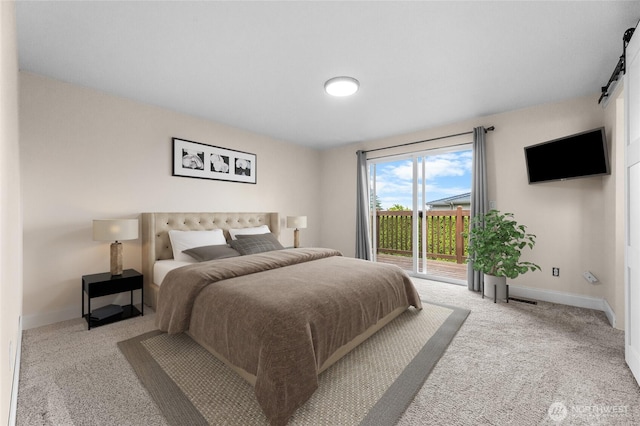 16912 49th St E, Lake Tapps, WA 98391 - bedroom featuring a barn door, access to exterior, carpet flooring, and baseboards