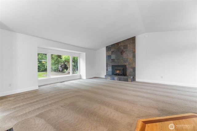 16912 49th St E, Lake Tapps, WA 98391 - unfurnished living room with vaulted ceiling, carpet, baseboards, and a tile fireplace