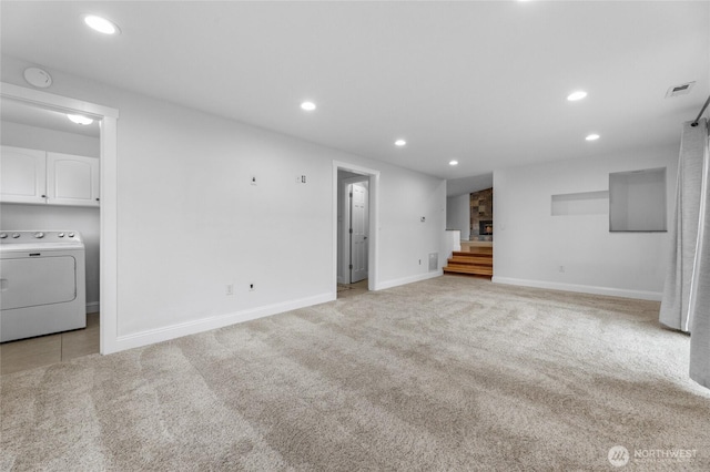 16912 49th St E, Lake Tapps, WA 98391 - unfurnished living room with washer / clothes dryer, stairs, light colored carpet, recessed lighting, and baseboards