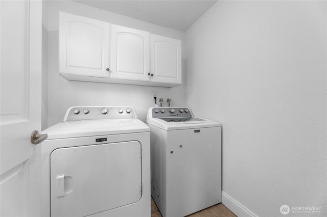 16912 49th St E, Lake Tapps, WA 98391 - laundry room featuring independent washer and dryer, cabinet space, and baseboards
