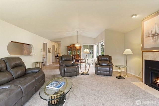2012 Creekside Ln, Anacortes, WA 98221 - living area featuring carpet, a tiled fireplace, lofted ceiling, a chandelier, and baseboards