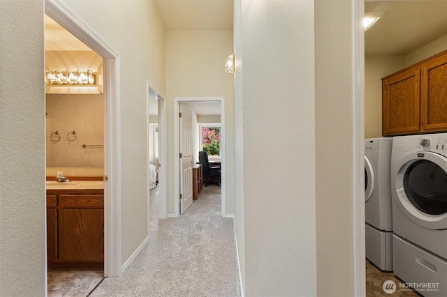 2012 Creekside Ln, Anacortes, WA 98221 - washroom featuring cabinet space, independent washer and dryer, and light carpet