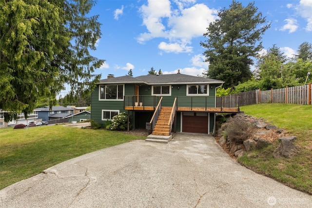 430 S 201st St, Des Moines, WA 98198 - view of front of house with driveway, an attached garage, a wooden deck, a chimney, and stairway